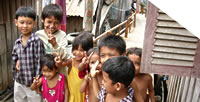 Photo of smiling children in a slum in Phnom Penh